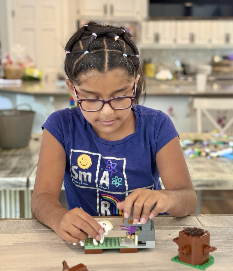 A young builder working on her model